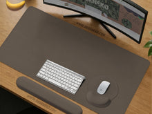 Dark monochrome desk mat with a circular yin yang koi fish design in flowing Japanese ink style.