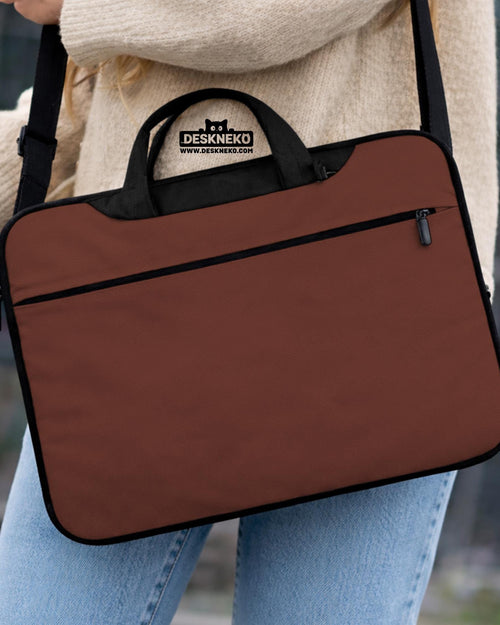 Brown laptop bag with a plain solid exterior, shown as a minimalist carrying case with handle and shoulder strap options.