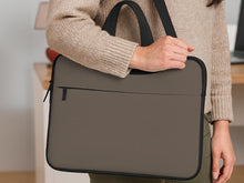 Cocoa brown laptop bag with a handle and detachable shoulder strap shown in a minimalist design.