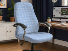 Office chair cover in a pastel blue checkered pattern shown on a chair in a home office setup.