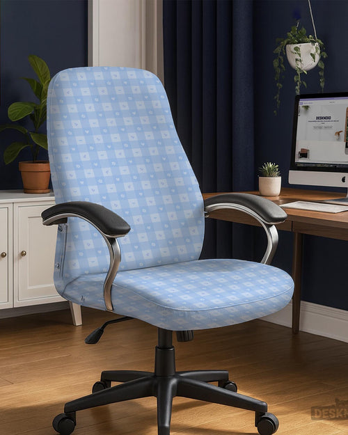 Office chair cover in a pastel blue checkered pattern shown on a chair in a home office setup.
