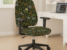 Desk chair cover with a green botanical print featuring leafy stems, white flowers, warm golden foliage, and small butterfly accents on a dark background.