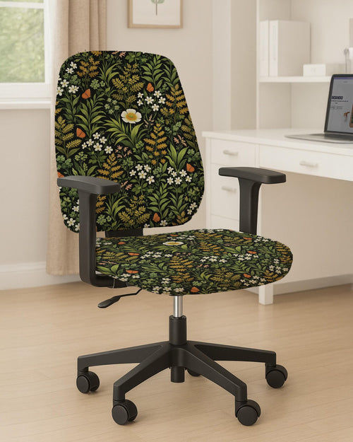 Desk chair cover with a green botanical print featuring leafy stems, white flowers, warm golden foliage, and small butterfly accents on a dark background.
