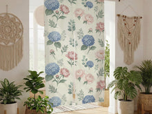 Floral noren curtain with pink peonies and blue hydrangeas on a cream background, shown as a split doorway curtain.