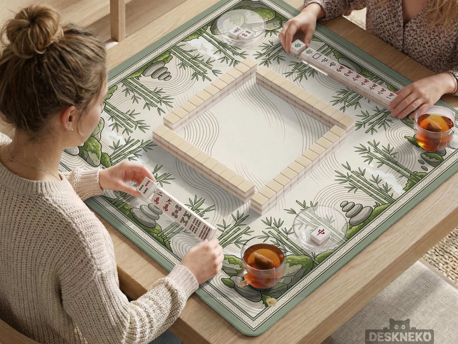 Square mahjong table mat with a bamboo garden design, green bamboo, stacked stones, and flowing sand lines on a cream background.