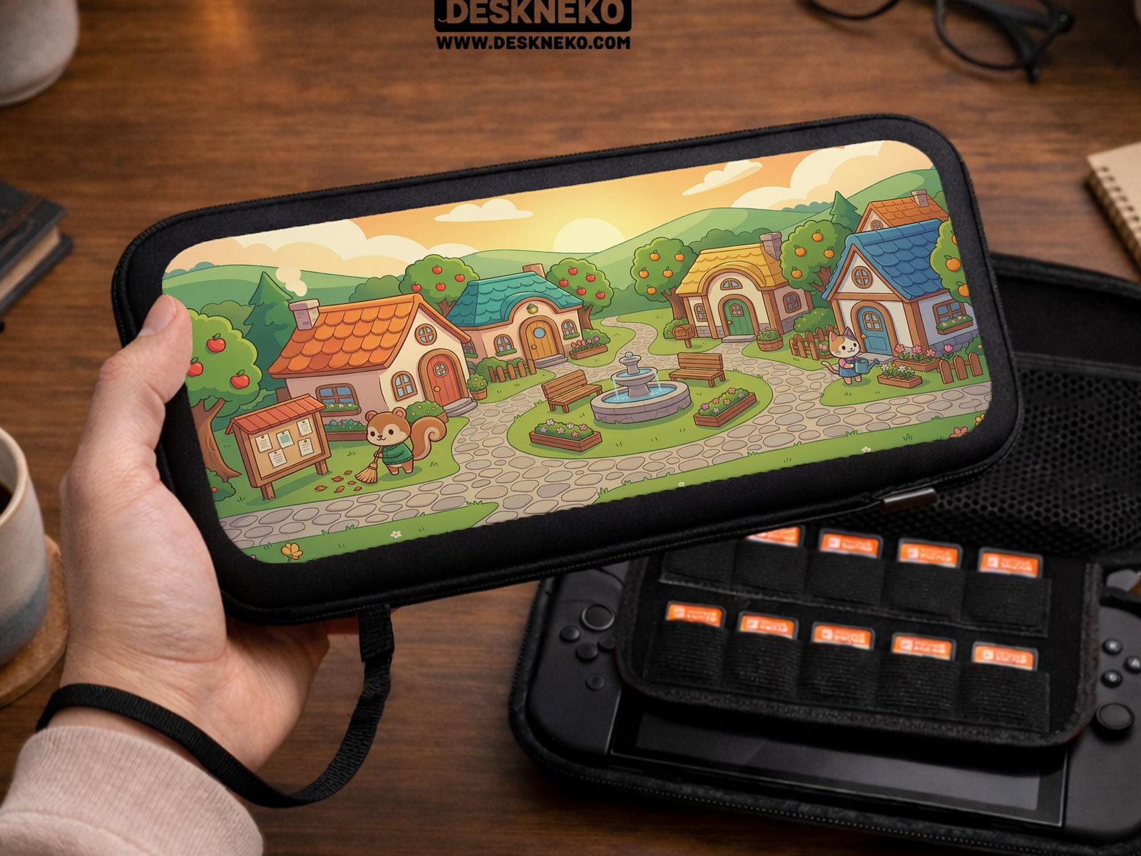 A Switch carrying case with a cottagecore village design showing small houses, winding paths, fruit trees, and animal figures in warm colors.