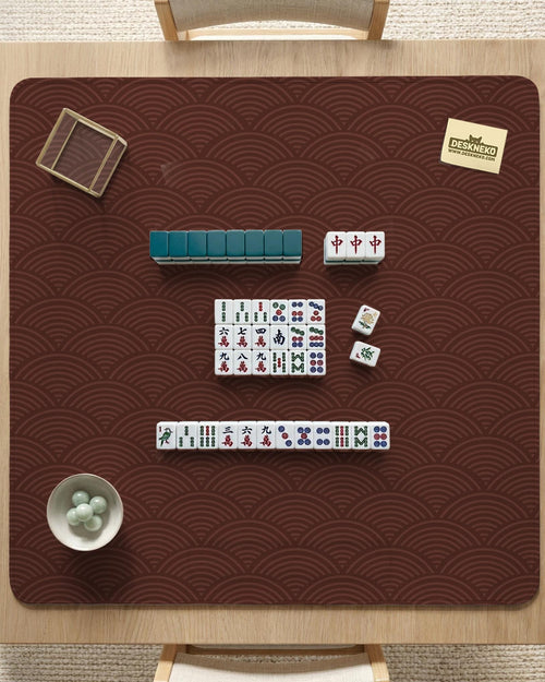 Square brown mahjong mat with a repeating seigaiha wave pattern in a decorative Japanese-style design.