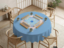 Pastel blue and pink floral square table cover with a scalloped center medallion and ornamental border.