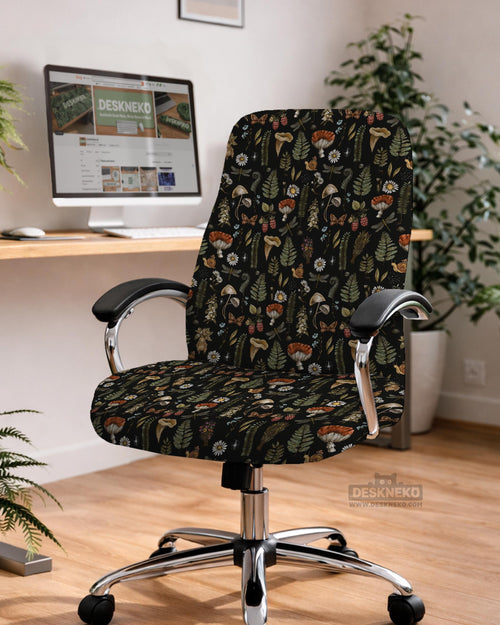 A black chair cover with a botanical print of mushrooms, ferns, daisies, berries, snails, and butterflies on a chair.