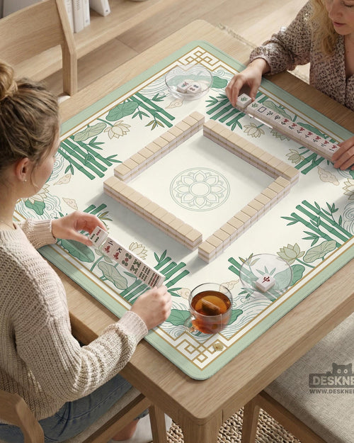 Sage green mahjong mat with bamboo leaves and lotus flowers printed across the surface.