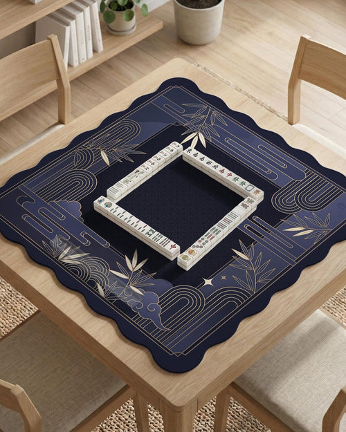Navy blue mahjong mat with bamboo line art border, art deco framing, and a dark open center.
