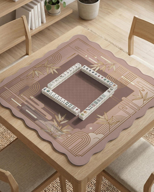 Square mahjong mat with a blush pink and rose gold design, bamboo accents, and art deco linework border.