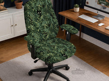 Green chair cover with a leafy botanical cat print shown on an office chair.