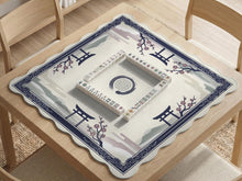 A navy square mahjong mat with a framed center and a sakura and torii design around the edges.