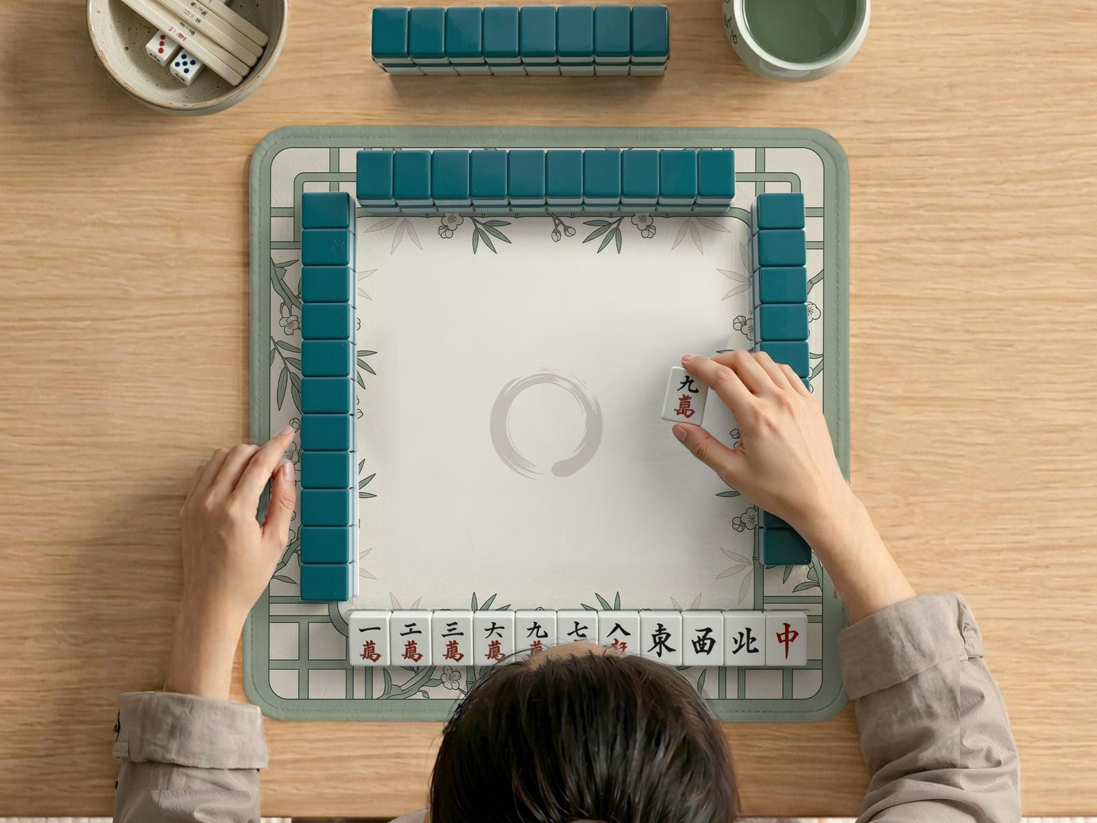 Square sage green mahjong mat with a bamboo and floral border and an open center.