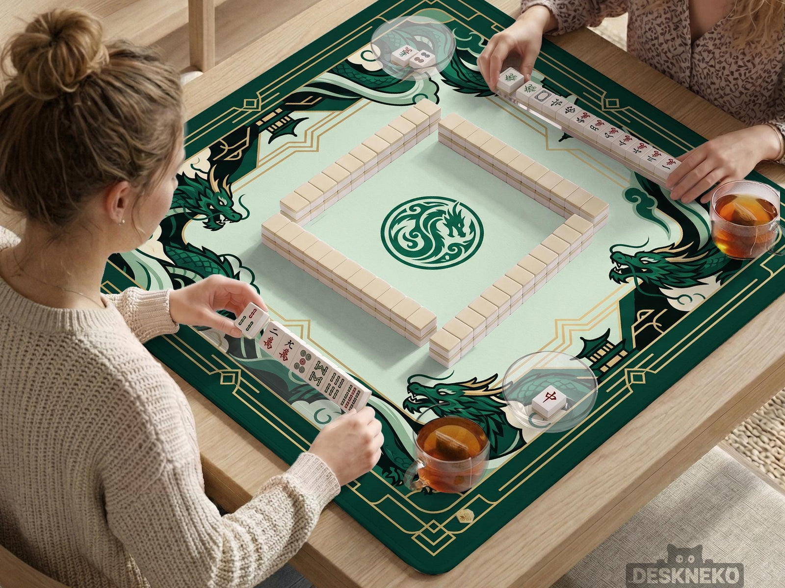 A square mahjong table mat with an emerald green dragon border, jade green center, cream details, and gold art deco accents.