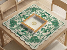 A square mahjong table mat with a green dragon and bamboo border on a cream background.
