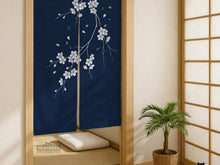 Navy door curtain with pink cherry blossom branches and a light floral layout on a dark background.