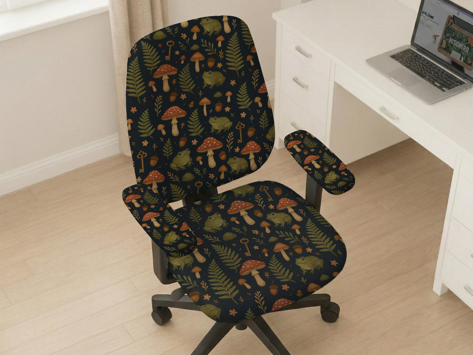 Desk chair cover with a dark forest print of frogs, mushrooms, and ferns in green and brown tones.