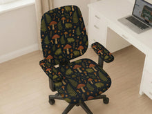 Desk chair cover with a dark forest print of frogs, mushrooms, and ferns in green and brown tones.