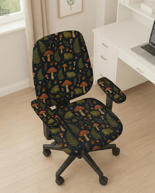 Desk chair cover with a dark forest print of frogs, mushrooms, and ferns in green and brown tones.