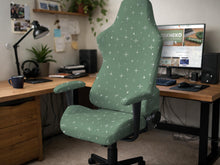 A sage green chair cover with a small white star pattern shown on a high back office or gaming chair.