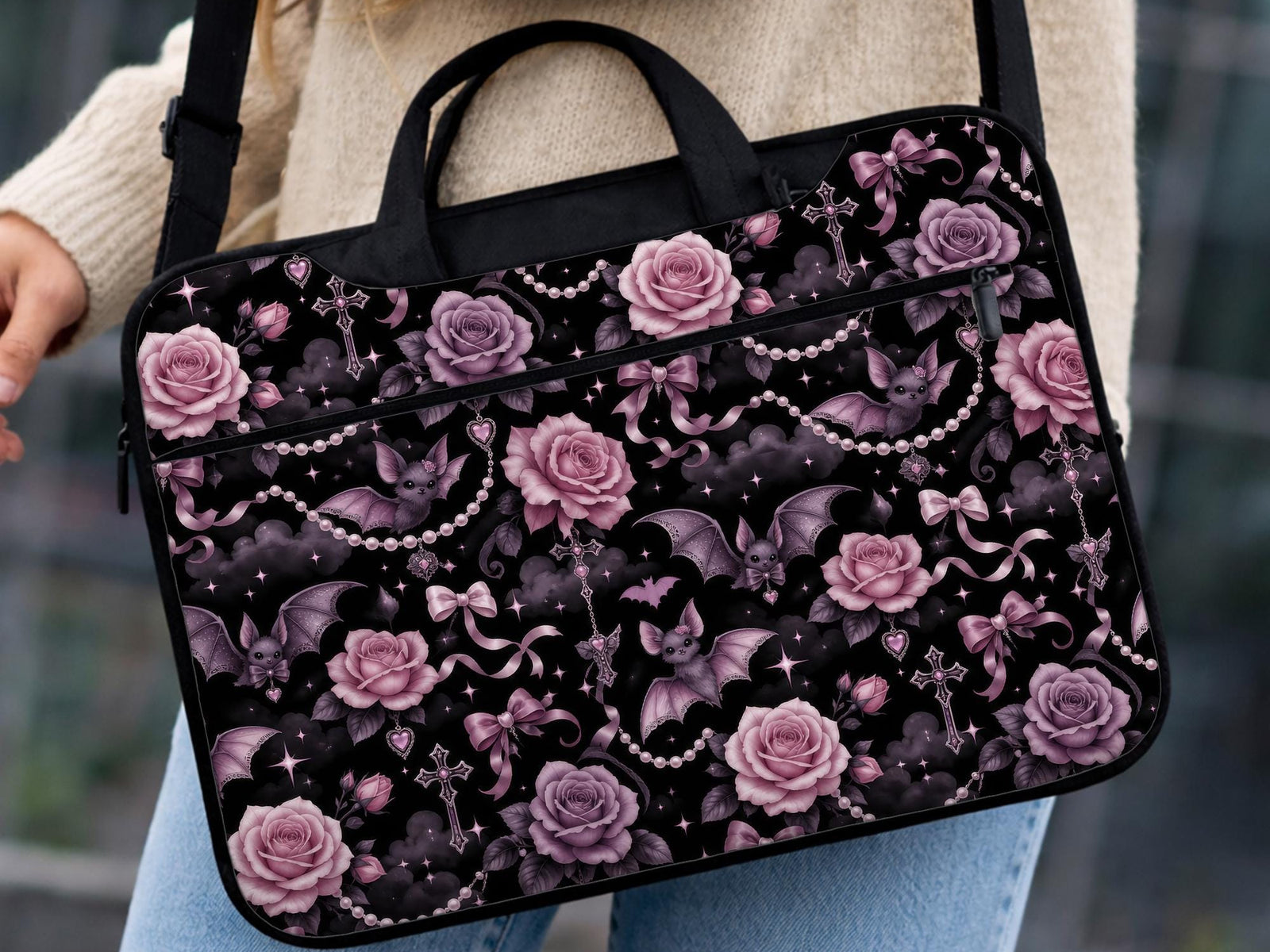 Pink laptop bag and sleeve design with small black bats, pink roses, pearl garlands, bows, and clouds on a black background.