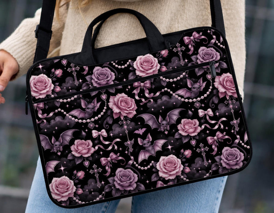 Pink laptop bag and sleeve design with small black bats, pink roses, pearl garlands, bows, and clouds on a black background.