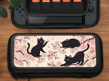 Pink Switch carrying case with a cherry blossom and black cat print on the front.