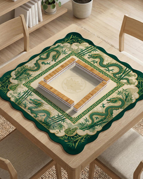 A scalloped mahjong mat with jade green dragon artwork, a bamboo border, and a cream center.