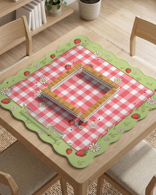 Pink checkered mahjong mat with strawberry and daisy illustrations on a light background.