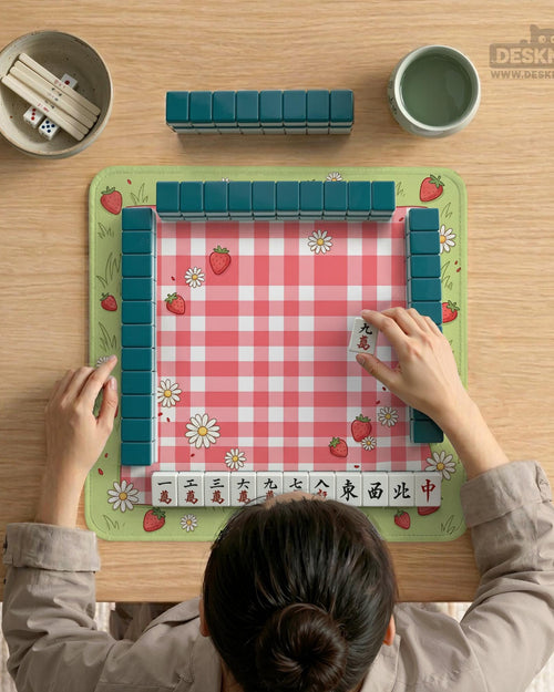 Pink gingham mahjong mat with strawberries, daisies, and sage green border details.