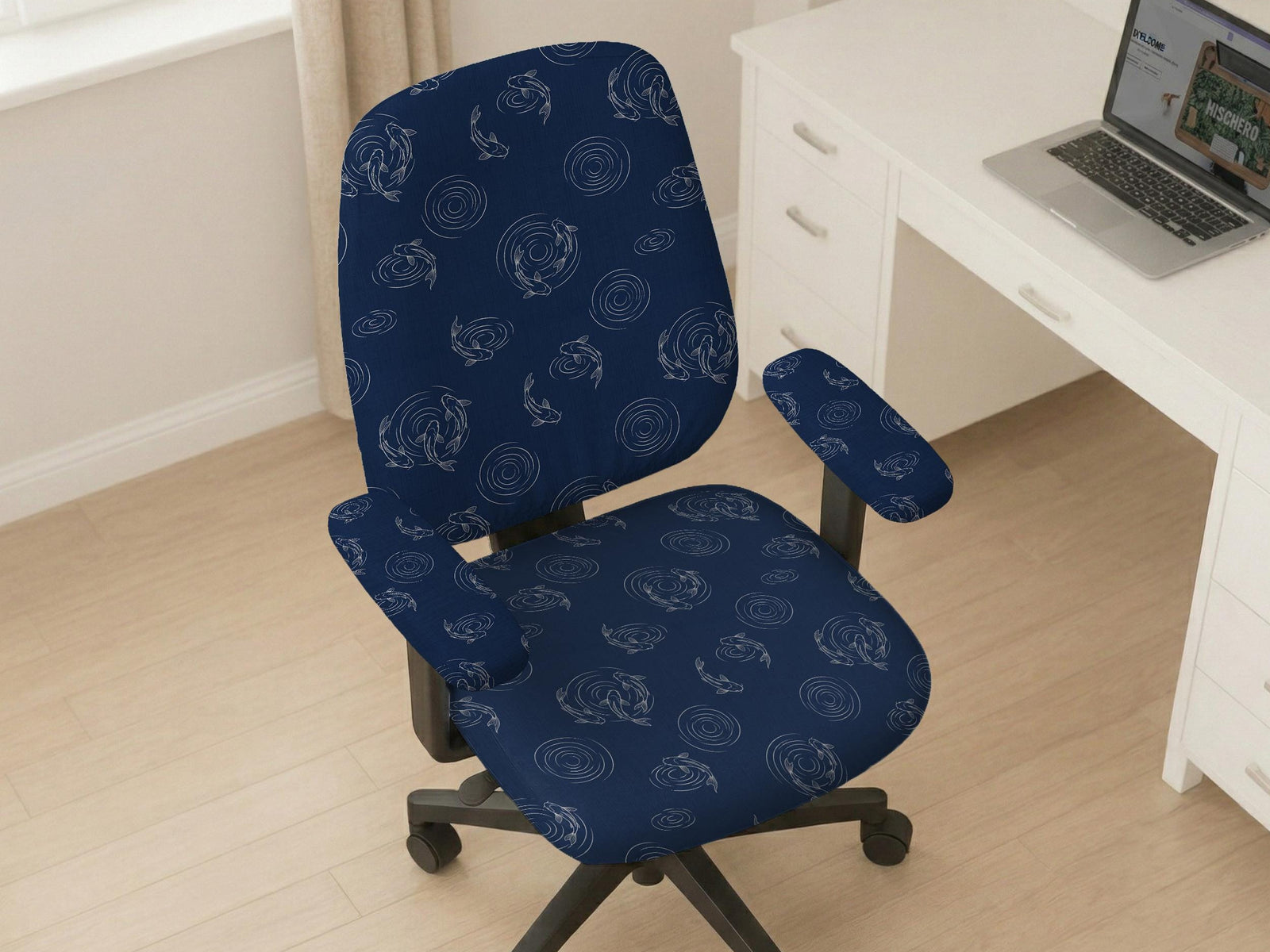 A navy blue desk chair cover with a koi fish print shown on a swivel chair with armrests.