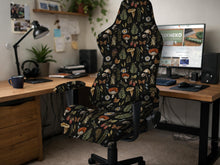Black chair cover with a mushroom and fern botanical print in dark green and brown tones.