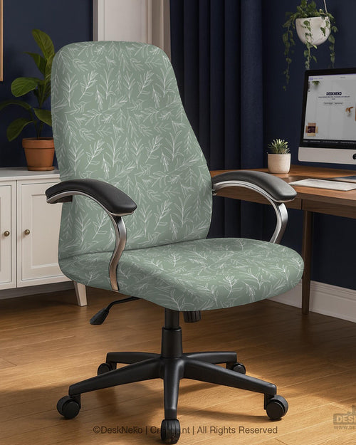 Office chair cover in muted sage green with a light leaf pattern on a white background.