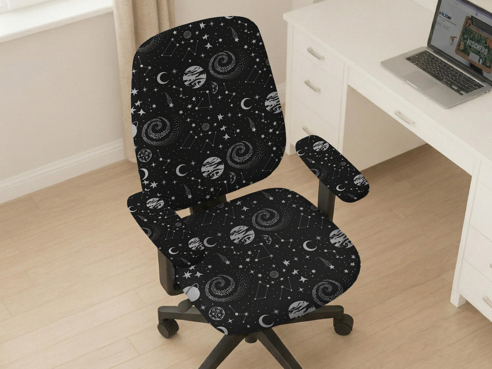 Desk chair cover in a black galaxy print with stars, moons, planets, and small zodiac-style details. The listing shows full chair, back-and-seat, seat-only, and armrest-only options.