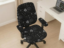 Desk chair cover in a black galaxy print with stars, moons, planets, and small zodiac-style details. The listing shows full chair, back-and-seat, seat-only, and armrest-only options.