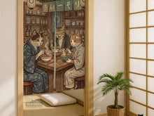 A split-panel Japanese noren curtain showing a ramen shop scene with three cats, warm lantern light, and vintage-style artwork in beige, muted teal, and brown tones.
