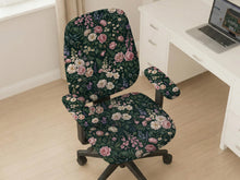 Green chair cover with a dark floral pattern, pink roses, cream flowers, and leafy botanical details on an office chair.