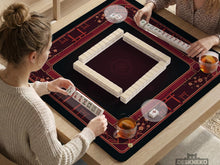 Square burgundy mahjong mat with a cherry blossom floral border and a dark open center.
