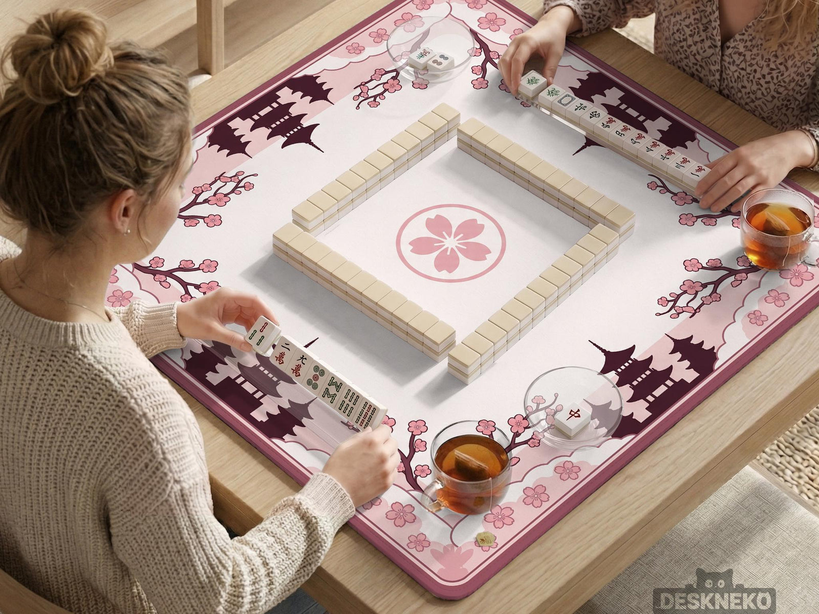 Pink mahjong table mat with cherry blossom and pagoda artwork around the border and an open center.