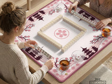 Pink mahjong table mat with cherry blossom and pagoda artwork around the border and an open center.