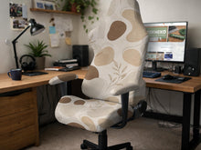 Beige and cream chair cover with an abstract boho pattern shown on a high-back gaming or office chair.