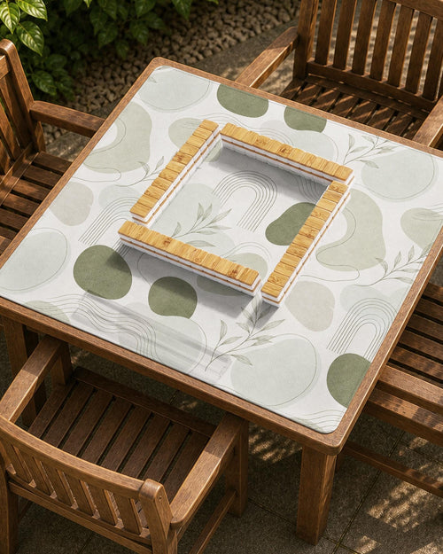 Square mahjong table mat with a sage green botanical design, abstract leaf shapes, and a soft neutral background.