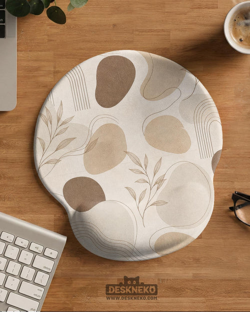 Beige ergonomic mouse pad with a neutral abstract botanical pattern and a raised wrist support area on one side.