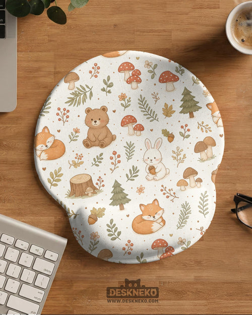 Cream mouse pad and keyboard wrist rest with a cottagecore forest animal pattern including foxes, bears, bunnies, mushrooms, and leafy branches.
