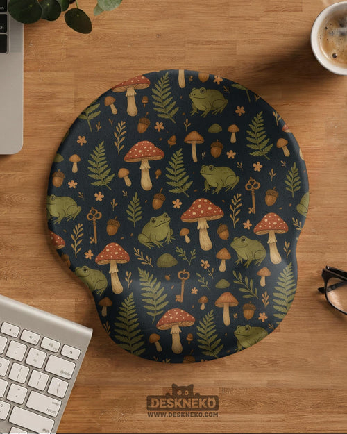 Mouse pad with a green frog, red mushrooms, fern leaves, tiny flowers, acorns, and old key details in a woodland pattern.