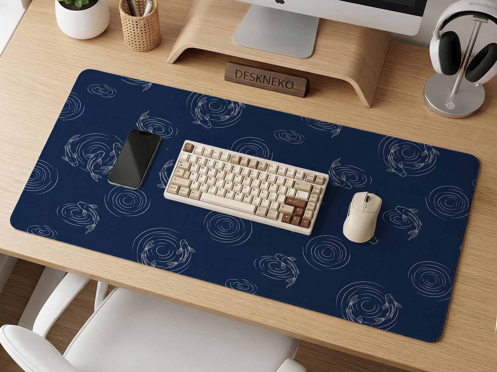 Navy desk mat with a Japanese koi fish ripple pattern and fine blue linework.