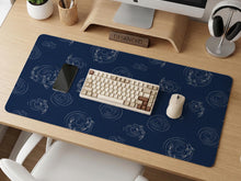 Navy desk mat with a Japanese koi fish ripple pattern and fine blue linework.