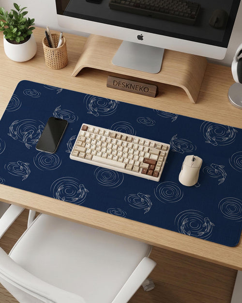 Navy desk mat with a Japanese koi fish ripple pattern and fine blue linework.